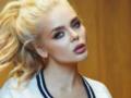 Гросу показала грудь в расстегнутом корсете, позируя на стуле