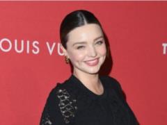 Pregnant Miranda Kerr with a tight dress emphasized a big tummy
