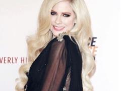 Smiling Avril Lavigne for the first time in two years appeared at a social event