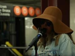 Unrecognizable Christina Aguilera in a hat and glasses performed in the metro