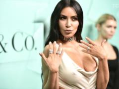 The skater Kim Kardashian in a white tight dress without underwear attended the party