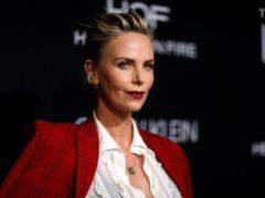 Charlize Theron with neckline to the navel appeared at the party and spoke sharply about motherhood