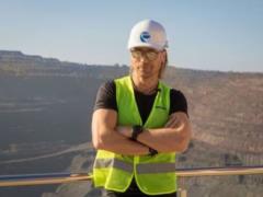 Funny Oleg Vinnik in a helmet drove a truck in a famous career