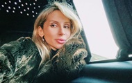 Loboda in a jacket on a naked body starred with a horse