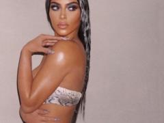 Kim Kardashian in lingerie erotically posed on the couch
