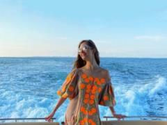 Dmitry Komarov s young wife in a light short dress posed on a yacht