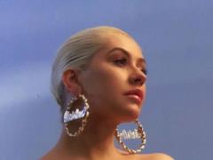 Christina Aguilera in the pool and with a glass of wine lit up to a cover of her own hit