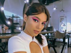 Playful Michelle Andrade flashes her breasts in a beige corset