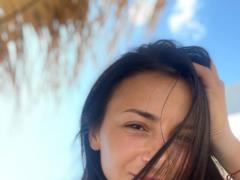 Ilona Gvozdeva in a brown bikini showed a relief body, bent over the stones