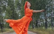 A fiery dress and a crushed Lexus: photo of the day