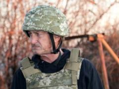 Sean Penn wearing berets with the inscription  
