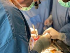 Doctors fit the first prosthetic mitral valve into a beating heart