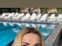 Olga Sumskaya in a dressing gown showed her slender legs by the pool