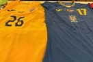 The national team of Ukraine plays against Romania in a blue kit, the opponent in a yellow one