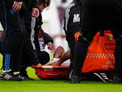 The Arsenal forward left the field on a stretcher