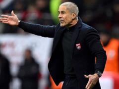 The Albanian coach assessed his opponent before the friendly game